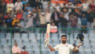 Indian batsman and team captain Virat Kohli raises his bat after scoring a century (100 runs) during the first day of the third Test cricket match between India and Sri Lanka at the Feroz Shah Kotla Cricket Stadium in New Delhi on December 2, 2017. AFP / 