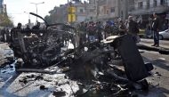 Emergency services and civilians gather at the scene of a car bomb explosion in a predominantly pro-government neighbourhood of the central Syrian city of Homs on December 5, 2107.AFP 