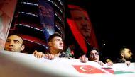 Demonstrators hold banners and a portrait of Turkey's President Tayyip Erdogan, during a protest against the U.S. intention to move its embassy to Jerusalem and to recognise the city of Jerusalem as the capital of Israel, near the U.S. Embassy in Ankara, 