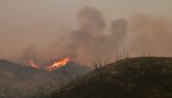 Fire rages from a mountaintop in the Los Padres National Forest north of Ojai, California on December 8, 2017. AFP / FREDERIC J. BROWN
