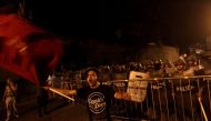 An opposition supporter waves a flag in front of soldiers during a protest over a contested presidential election with allegations of electoral fraud in Tegucigalpa, Honduras, December 8, 2017. REUTERS/Jorge Cabrera
