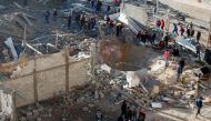 Palestinians gather around a militant target that was hit in an Israeli airstrike in the northern Gaza Strip December 9, 2017. REUTERS/Mohammed Salem