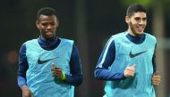 Qatar’s Karim Boudiaf (right) and a team-mate train under the watchful eyes of coach Felix Sanchez.