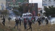 Palestinians clash with Israeli soldiers during a demonstration against U.S. President Donald Trump's recognition of Jerusalem as Israel's capital, in Nablus, West Bank on December 13, 2017. ( Nedal Eshtayah - Anadolu Agency ).
