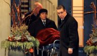 One of two bodies is removed from the home of billionaire founder of Canadian pharmaceutical firm Apotex Inc., Barry Sherman and his wife Honey, who were found dead under circumstances that police described as 