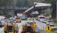 Rescue personnel and equipment are seen at the scene where an Amtrak passenger train derailed on a bridge over interstate highway I-5 in DuPont, Washington, US December 18, 2017. Reuters/Steve Dipaola