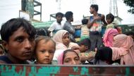 Rohingya refugees travel on an open-back truck on Teknaf-Cox's Bazar highway near Kutupalong refugee camp in Ukhiya, Bangladesh, on September 3, 2017. Photo by Jasmin Rumi/AFP.