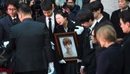Family members and friends of late SHINee singer Kim Jong-Hyun cry as they carry out his coffin during a funeral at a hospital in Seoul on December 21, 2017. AFP / JUNG Yeon-Je

