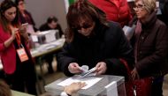 Voters cast their ballots at polling station for the Catalan regional parliamentary elections, between separatists and pro-unity Catalans, in Barcelona, Spain on December 21, 2017. ( Burak Akbulut - Anadolu Agency ).