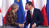 Poland’s Prime Minister Mateusz Morawiecki and Britain’s Prime Minister Theresa May shake hands during a news conference in Warsaw, Poland December 21, 2017. Slawomir Kaminski/Agencja Gazeta/ REUTERS 