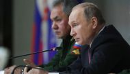 Russian President Vladimir Putin and Defence Minister Sergei Shoigu attend a meeting of Russia's top military brass in Balashikha outside Moscow on December 22, 2017. / AFP / SPUTNIK / Mikhail KLIMENTYEV
