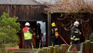 London Fire Brigade firefighters control a fire that broke out at a cafe and shop at London Zoo in London on December 23, 2017.   AFP / DANIEL LEAL-OLIVAS
