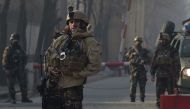 Afghan security personnel keep watch near the site of a suicide attack in Kabul on December 25, 2017. AFP / Shah Marai 

