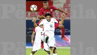 Qatar’s Assim Madibo (top) vies for the ball during the opening match of the Gulf Cup on Saturday.