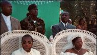 A file photo of then Liberian warlord and presidential aspirant Charles Taylor and Deputy Governor of the National Bank of Liberia Jewel Howard (both seated), who married January 28, in the central Liberian town of Gbarnga July 26, 1996. / AFP / FRANCOIS 