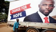 A supporter of George Weah, former soccer player and presidential candidate of Coalition for Democratic Change (CDC), listens to the announcement of the presidential election results on the radio, in Monrovia, Liberia December 27, 2017. REUTERS/Thierry Go