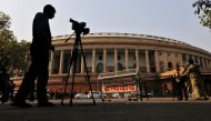 Television journalists report from the premises of India's Parliament in New Delhi, India, February 13, 2014. REUTERS/Adnan Abidi/File Photo
