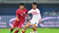 Qatar's Akram Afif (L) vies for the ball with Bahrain's Reda Issa (R) during the 2017 Gulf Cup of Nations football match between Qatar and Bahrain at the Sheikh Jaber al-Ahmad Stadium in Kuwait City on December 29, 2017.  AFP / GIUSEPPE CACACE
