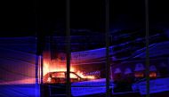 Cars burn during a blaze engulfing vechiles parked at a multi-storey car park near the Echo Arena, at the waterfront in Liverpool on December 31, 2017. / AFP / Paul ELLIS