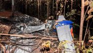 The tail of the burned fuselage of a small plane that crashed is seen in Guanacaste, Corozalito, Costa Rica on December 31, 2017. / AFP.