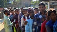 People stand in line to check their names on the first draft of the National Register of Citizens (NRC) at Gumi village of Kamrup district in the Indian state of Assam on January 1, 2018. AFP / Kulendu Kalita
