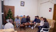 A handout picture released on the official Facebook page of the Syrian Presidency on December 29, 2017 shows Syrian President Bashar al-Assad (3-L), his wife Asma (2-R), his daughter Zein (C), and his sons Hafez (3-R) and Karim (4-R), visiting injured arm