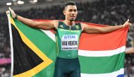 This file photo taken on August 10, 2017 shows South Africa's Wayde Van Niekerk celebrating after winning second place in the final of the men's 200m athletics event at the 2017 IAAF World Championships at the London Stadium in London. AFP / Jewel Samad 