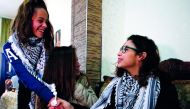Nour Tamimi (right), is welcomed home by a relative in the West Bank village of Nabi Saleh yesterday, after being released from a military prison. 
