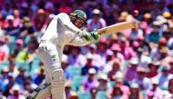 Australia's batsman Usman Khawaja lofts a ball away from England's bowling on the third day of the fifth Ashes cricket Test match at the SCG in Sydney on January 6, 2018. / AFP / WILLIAM WEST /