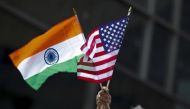 A man holds the flags of India and the US while people take part in the 35th India Day Parade in New York August 16, 2015. REUTERS/Eduardo Munoz/Files