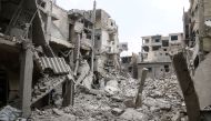 Wreckages of collapsed buildings are seen after Assad Regime's airplanes carried out airstrike over the besieged town of Arbin in Eastern Ghouta in Damascus, Syria on January 4, 2018. Ammar Al Bushy - Anadolu
