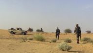 File photo of fighters from the Tuareg separatist rebel group MNLA walk in the desert near Tabankort, February 15, 2015. REUTERS/Souleymane Ag Anara 