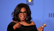 Oprah Winfrey poses backstage with her Cecil B. DeMille Award. REUTERS/Lucy Nicholson
