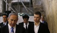 FILE PHOTO: Yair Netanyahu observes his father Israeli Prime Minister Benjamin Netanyahu reading a prayer at the Western Wall in Jerusalem's Old City (Ronen Zvulun / Reuters) 