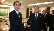 South Korea's Unification Minister Cho Myung-Gyun (L) shakes hands with North Korean chief delegate Ri Son-Gwon (2nd L) after their meeting at the border truce village of Panmunjom in the Demilitarized Zone (DMZ) dividing the two Koreas on January 9, 2018