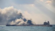 Smoke and flames coming from the burning oil tanker 