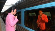 Elvis Presley impersonator Brody Finlay looks at his reflection in a window of the Elvis Express train at Sydney's Central station before it departs for the 26th annual Elvis Festival being held in the New South Wales town of Parkes in Australia, January 