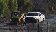 A vehicle is removed from a road along US Highway 101, January 10, 2018 after a massive mudflow in Montecito, California flooded the highway, causing a 30 mile long stretch of the road connecting Los Angeles and San Francisco to be closed. AFP / Robyn Bec