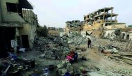 A Syrian family cooks amid the rubble in Raqqa, the former ‘capital’ of the Islamic State group in Syria, yesterday.
