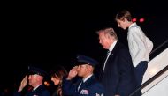 US President Donald Trump, son Barron and wife Melania step off Air Force One upon arrival at Palm Beach International Airport in West Palm Beach, Florida on January 12, 2018. AFP / Nicholas Kamm
