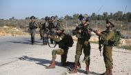 Israeli security forces intervene protestors during a demonstration to protest against U.S. decision to recognize Jerusalem as Israel's capital and to show their support for the Palestinian prisoners in Israeli jails, at Nebi Saleh village of Ramallah, We