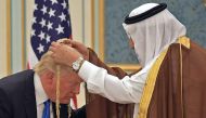 US President Donald Trump (C) receiving the Order of Abdulaziz al-Saud medal from King Salman bin Abdulaziz al-Saud of Saudi Arabia at the Saudi Royal Court in Riyadh on May 20, 2017. AFP / Mandel Ngan