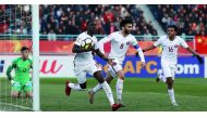 Qatari striker Almoez Ali carries the ball as he celebrates with team-mates  Ahmad Moein (centre) and  Hashim Ali (right) after scoring his first goal against China during their AFC U-23 Asian Cup match played in Changzhou, China yesterday.