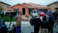 Media gather in front of 160 Muir Woods Road in Perris, California, from where authorities rescued 13 malnourished children held captive by their parents, on January 15, 2018. / AFP / Bill Wechter