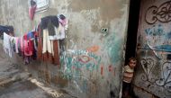 A Palestinian boy looks out of his family's house in Al-Shati refugee camp in Gaza City January 15, 2018. Picture taken January 15, 2018. Reuters/Mohammed Salem