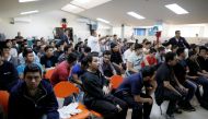 File photo: Deportees wait to be processed at an immigration facility after a flight carrying illegal immigrants from the US arrived in San Salvador, El Salvador, January 11, 2018. REUTERS/Jose Cabezas/File Photo