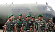 File picture of Indonesia army soldiers walking near a Hercules C-130 in Pangkalan Bun district, December 31, 2014. Indonesia has suspended military cooperation with Australia after offensive training materials were found at an Australian army centre. Reu