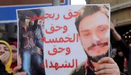 Egyptian activists holds a poster calling for justice for Giulio Regeni during a demonstration in Cairo, April 15, 2016 (Reuters) 