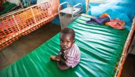 A malnourished child sits on May 30, 2017 on a bed at the clinic run by Doctors Without Borders in Aweil, Northern Bahr al Ghazal, South Sudan. (AFP / Albert Gonzalez Farran) 