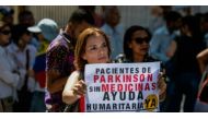 (FILE PHOTO) A woman holds a sign during an anti-government demonstration protesting the shortage of medicines in Caracas, Venezuela on November 20, 2017. AFP